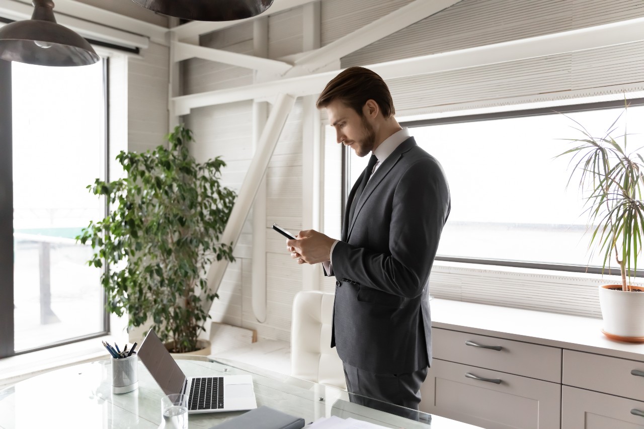 Man with laptop and mobile phone